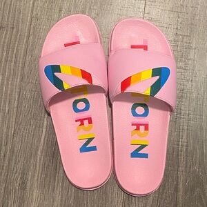 Tretorn pink slides with rainbow lettering and design
